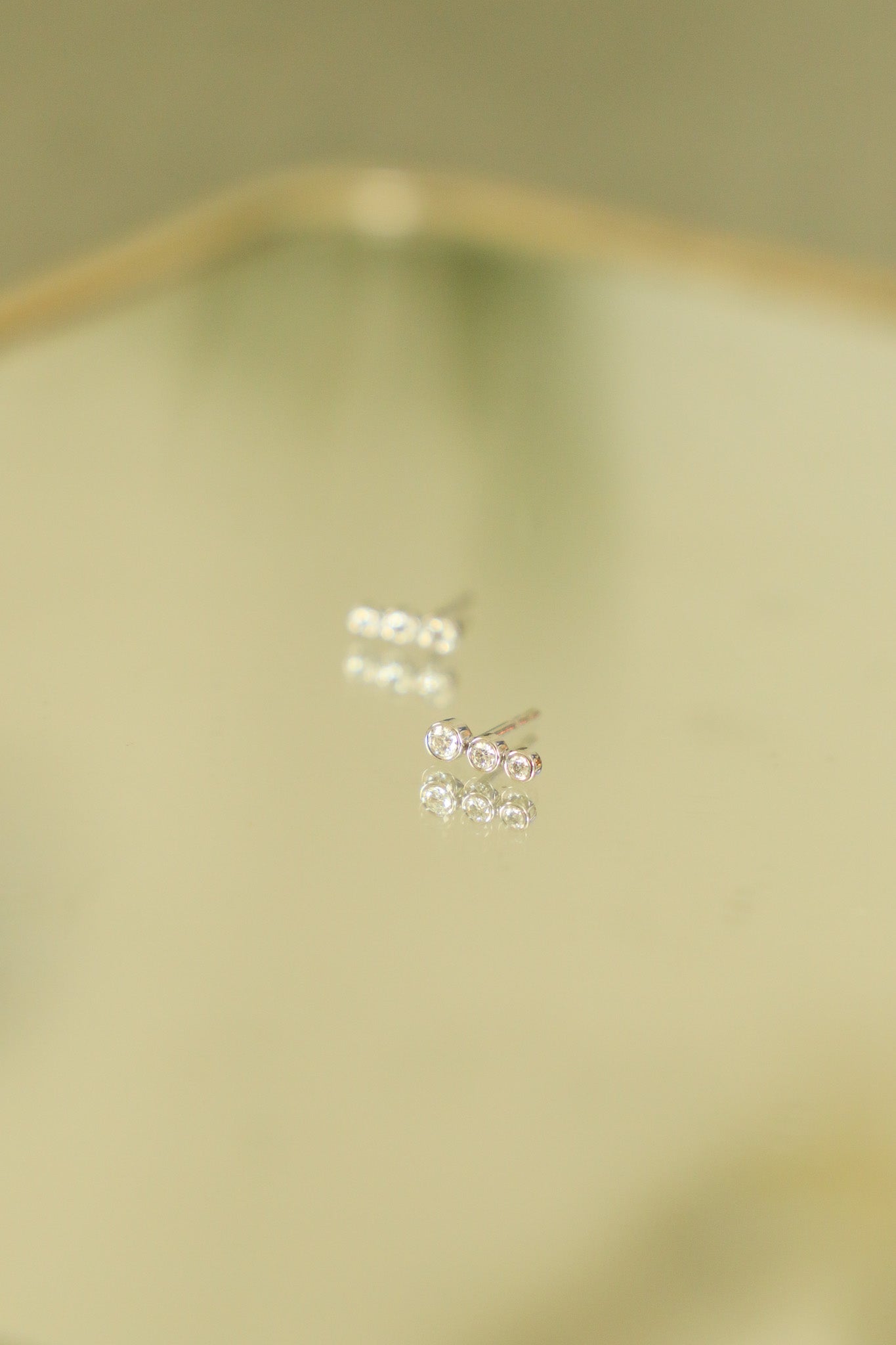 E163 - 14k WG Studs w/6 Bezel Set Round Diamonds 0.19cts (3x9mm)