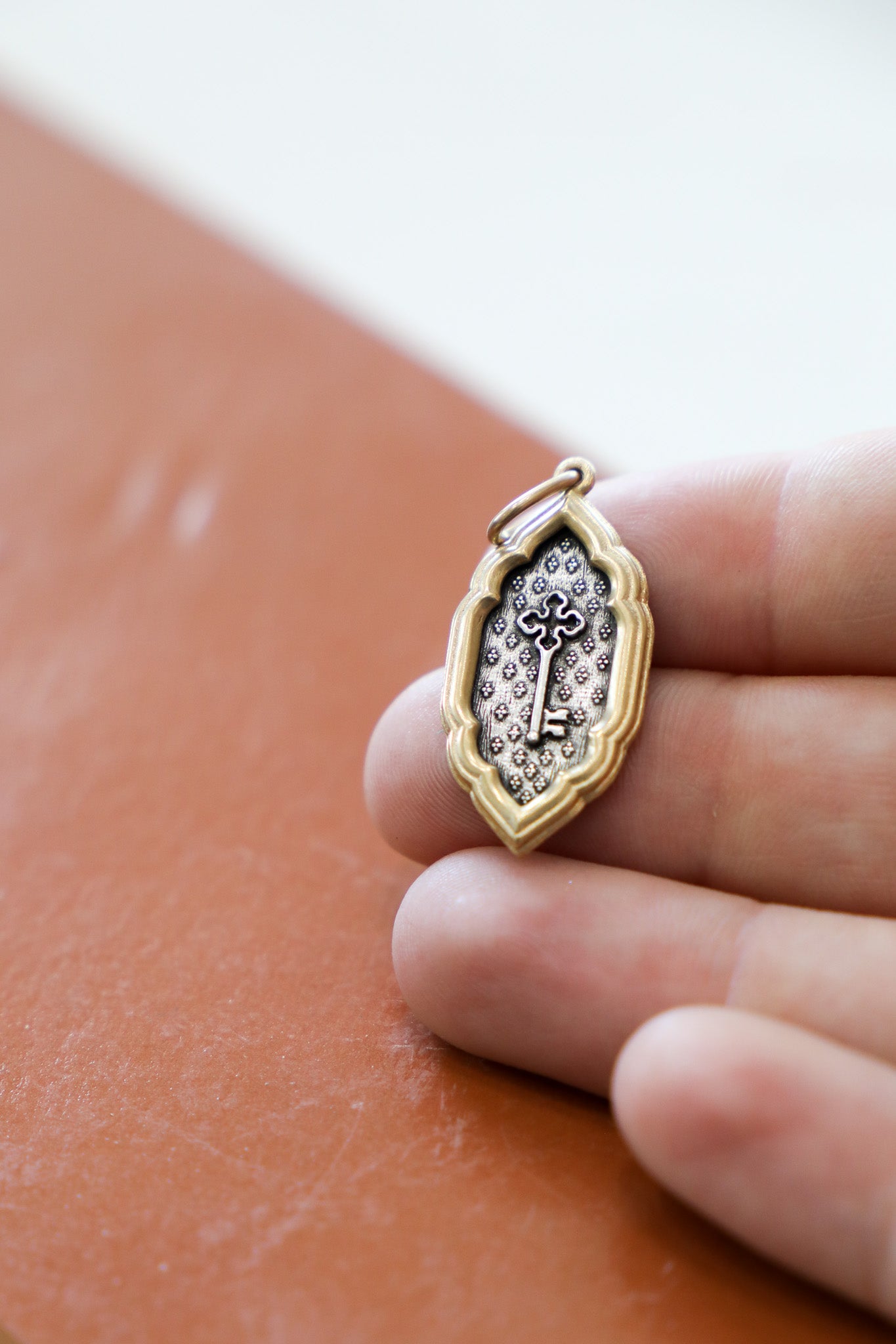 EM c241c - SS/18k Elongated Cross Key & Heart "Who, Being Loved Is Poor"